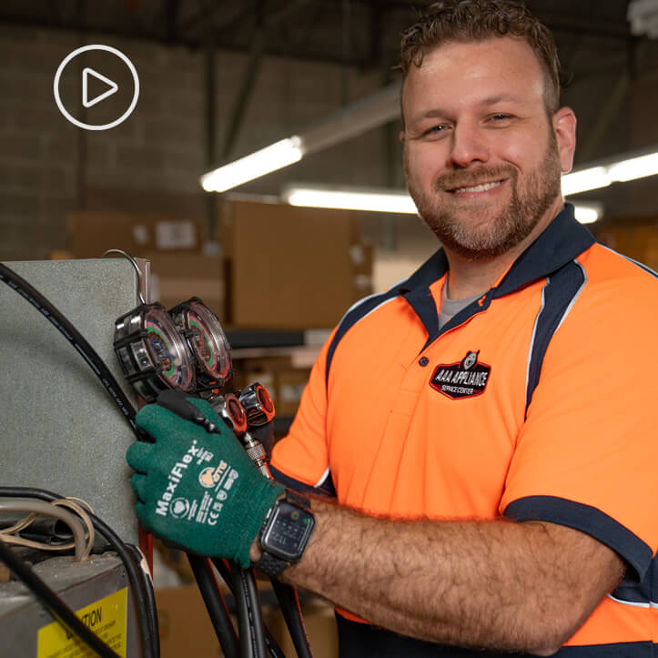 AAA Appliance repair technician with diagnostic equipment.